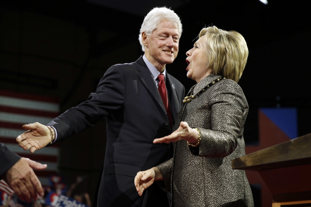 Democratic presidential candidate Hillary Clinton stands with former President Bill Clinton at her presidential primary election night rally Tuesday