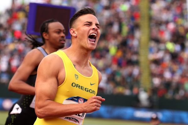 Devon Allen crosses the finish line to place