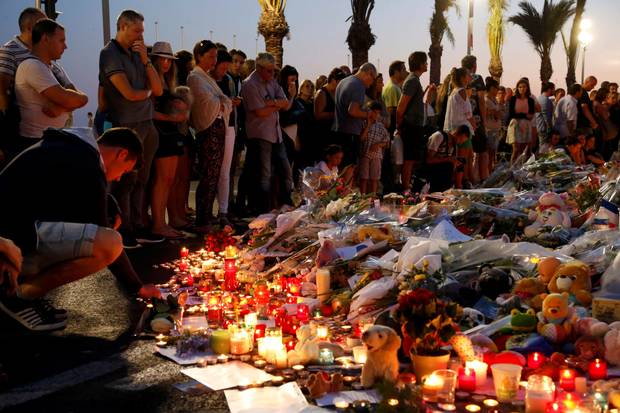 Distraught mourners leave flowers for the terror attack victims