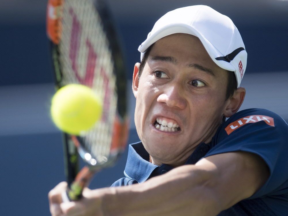 Kei Nishikori of Japan returns the ball to Stanislas Wawrinka of Switzerland during men's semifinal Rogers Cup tennis action in Toronto on Saturday