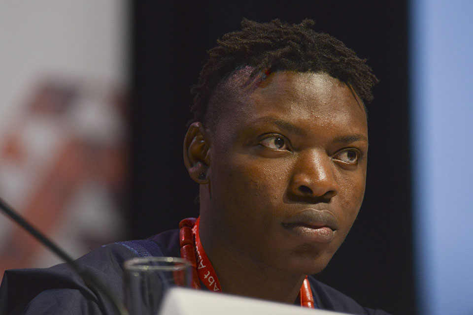 Michael Ighodaro a Nigerian activist that works for the AIDS Vaccine Advocacy Coalition listens to a speaker during the morning plenary session at AIDS 2016 in Durban South Africa