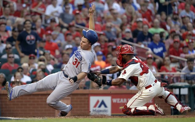 Los Angeles Dodgers Joc Pederson left is tagged out at home by St. Louis Cardinals catcher Alberto Rosario during the sixth inning of a baseball game Satu