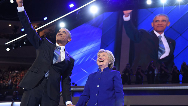 U.S. President Barack Obama waves with U.S. Presidential nominee Hillary Clinton during the third night of the Democratic National Convention at the Wells Fargo Center in Philadelphia Pennsylvania