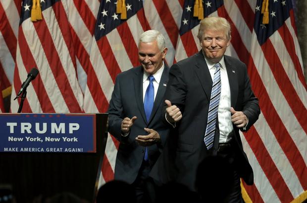 Republican presidential candidate Donald Trump points to Indiana Gov. Mike Pence after introducing Pence as his vice presidential running mate in New York City