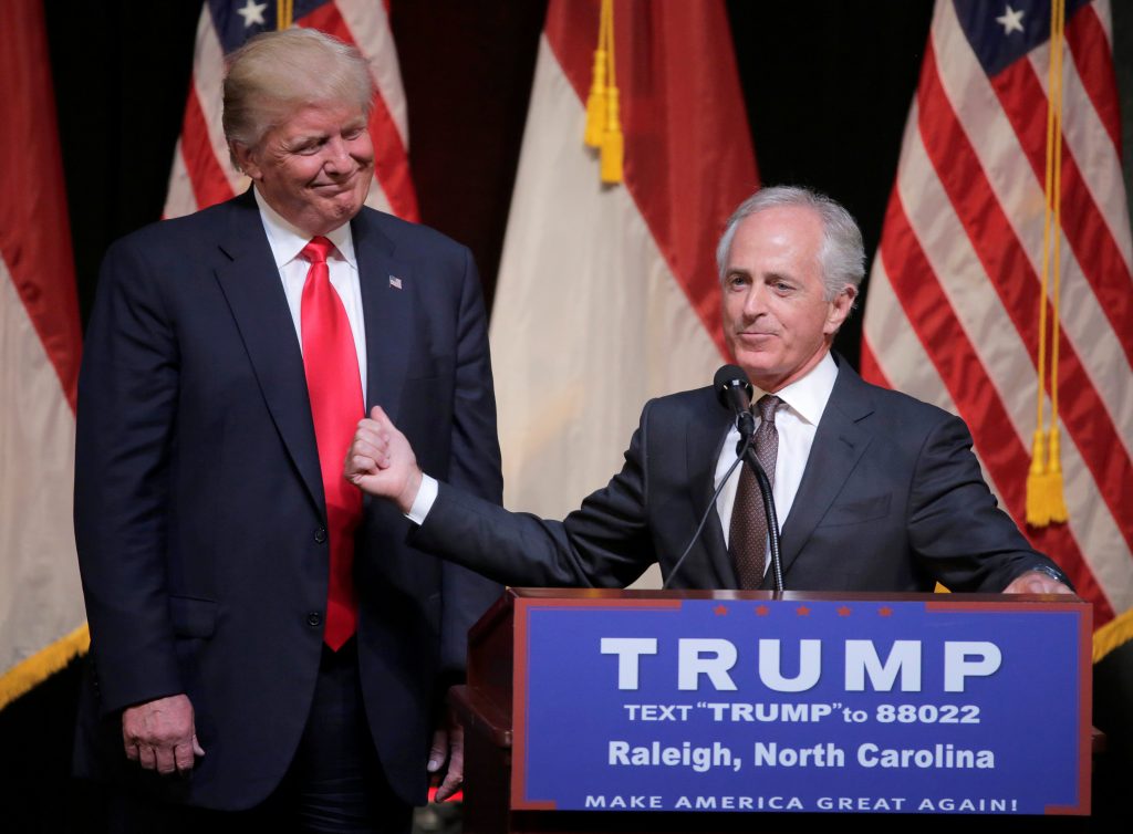 Donald Trump listens as Senator Bob Corker R-Tenn speaks at a campaign rally in Raleigh North Carolina