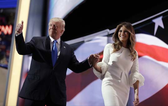 Republican presidential candidate Donald Trump gives his thumb up as he walks off the stage with his wife Melania during the Republican National Convention Monday