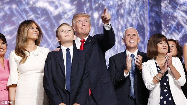 The future's bright Donald Trump is joined on stage by his mini-me 10-year-old son Barron while his wife Melania is left with Vice Presidential nominee Mike Pence and his wife Karen to the right at the end of the mogul's epic speech