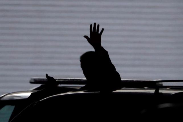 U.S. Republican presidential candidate Donald Trump waves to the media as he leaves the Conrad Hotel in Indianapolis Indiana