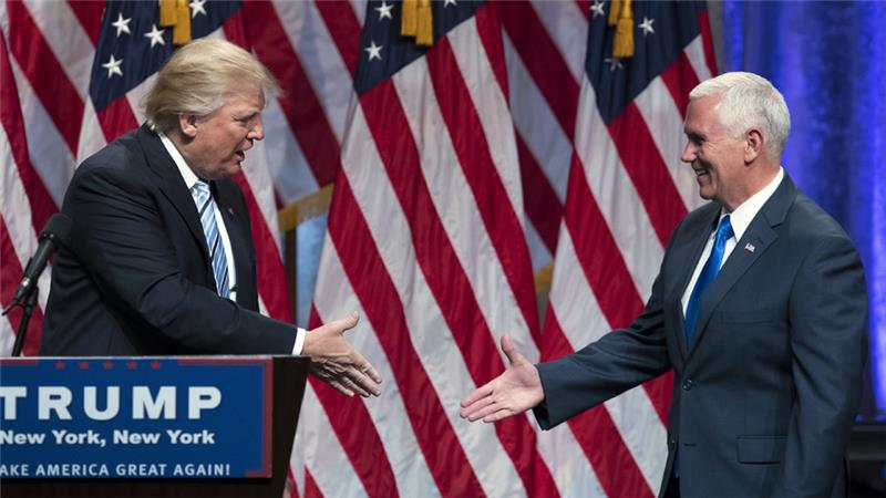 Donald Trump shakes hands with Mike Pence during a campaign event in New York