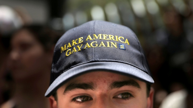 A man wears a hat that says 'Make America Gay Again,&#39 a parody of Donald Trump's campaign slogan. Trump courted gay GOP voters in his prime-time pitch to the nation Thursday at the Republican convention in Cleveland