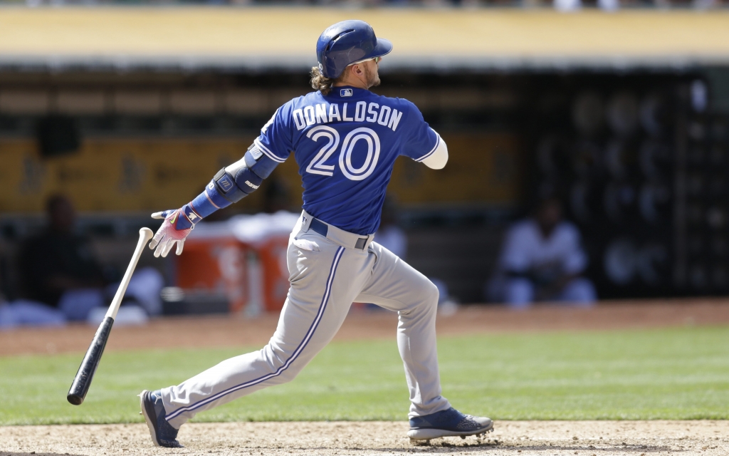 Toronto Blue Jays&#039 Josh Donaldson swings for a two-run double off Oakland Athletics&#039 John Axford in the ninth inning of a baseball game Sunday