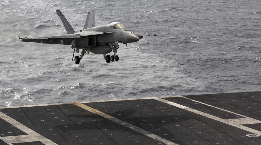 A US Navy F  A-18 aircraft prepares to land on the runway of the US Navy aircraft carrier USS George Washington during a tour of the ship in the South China Sea