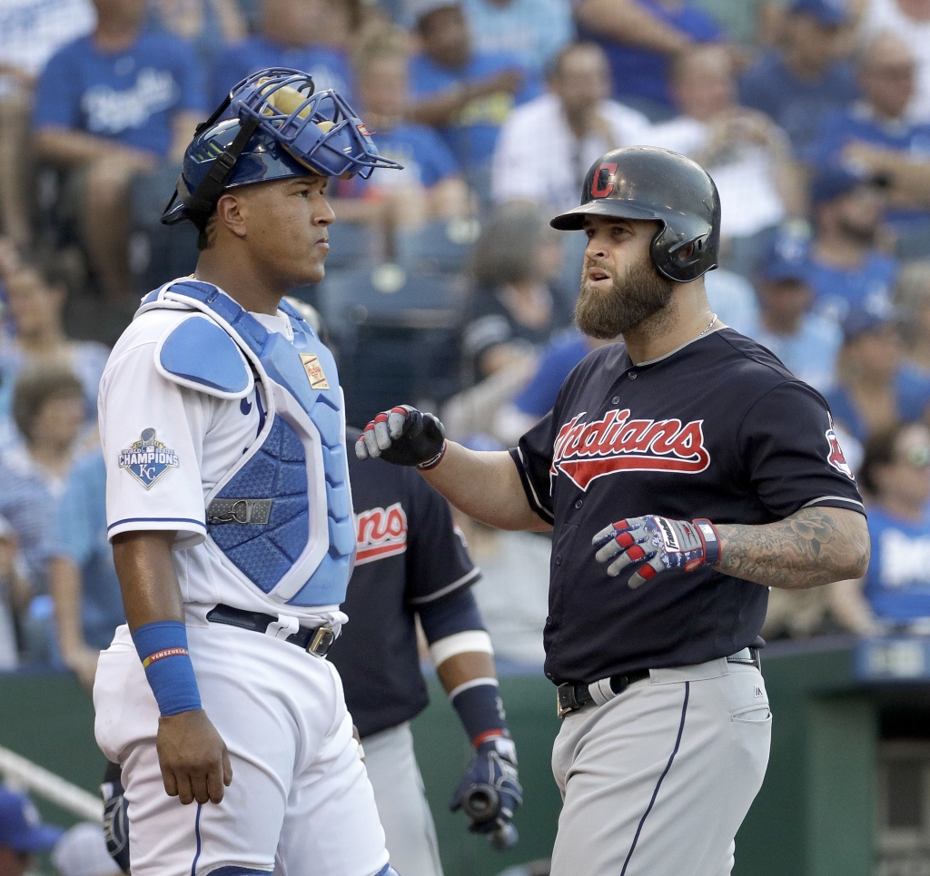 Cleveland Indians&#039 Mike Napoli runs past Kansas City Royals catcher Salvador Perez to score after hitting a two-run home run during the first inning of a baseball game Tuesday