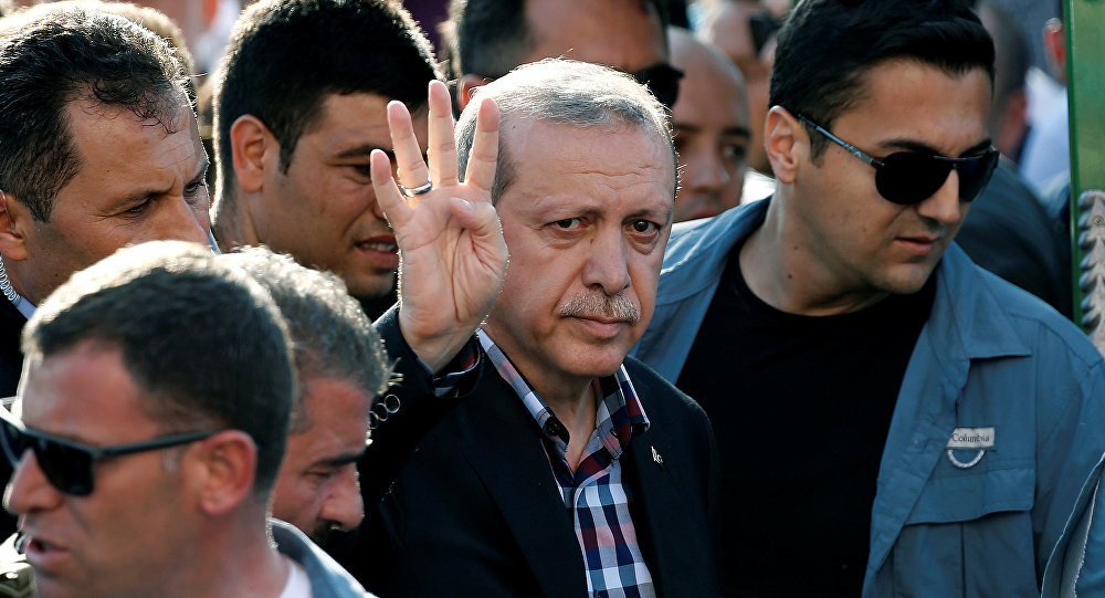 Turkish President Recep Tayyip Erdogan waves to the crowd following a funeral service for a victim of the thwarted coup in Istanbul Turkey