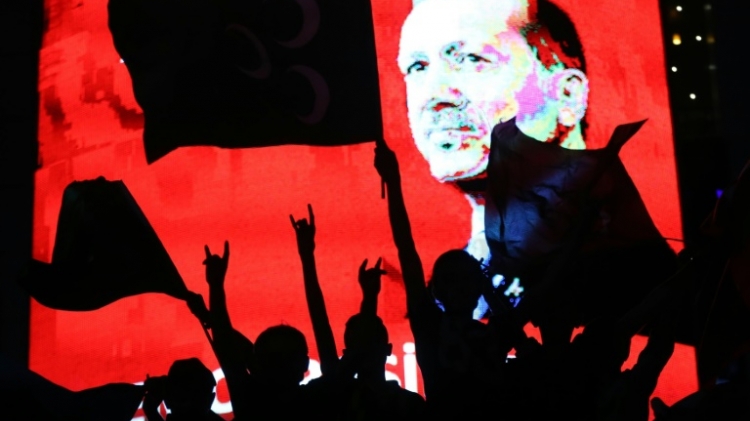 Erdogan's supporters in front of a screen showing his