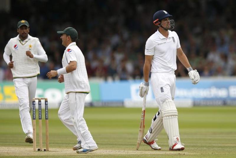 England's Alastair Cook walks off the field after being dismissed