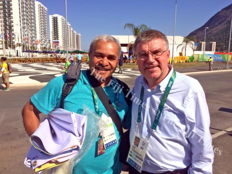 Matai Akauola with International Olympic Committee president Thomas Bach at the Games Village