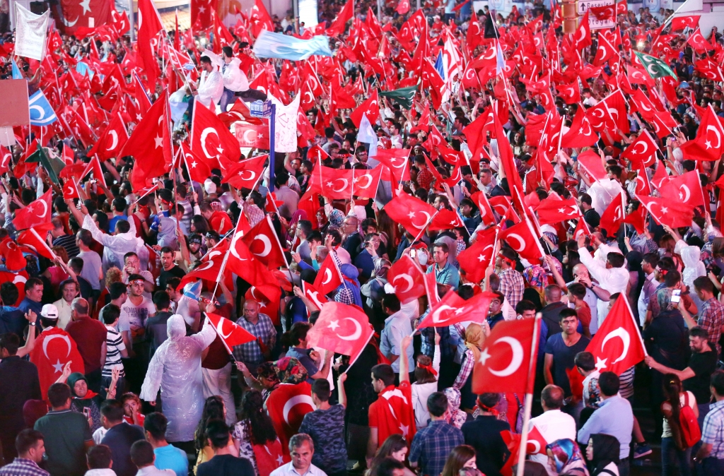 AP_16202738386210-3 Supporters of Turkish President Recep Tayyip Erdogan wave national flags Wednesday in Ankara at a pro-government rally at Kizilay main square