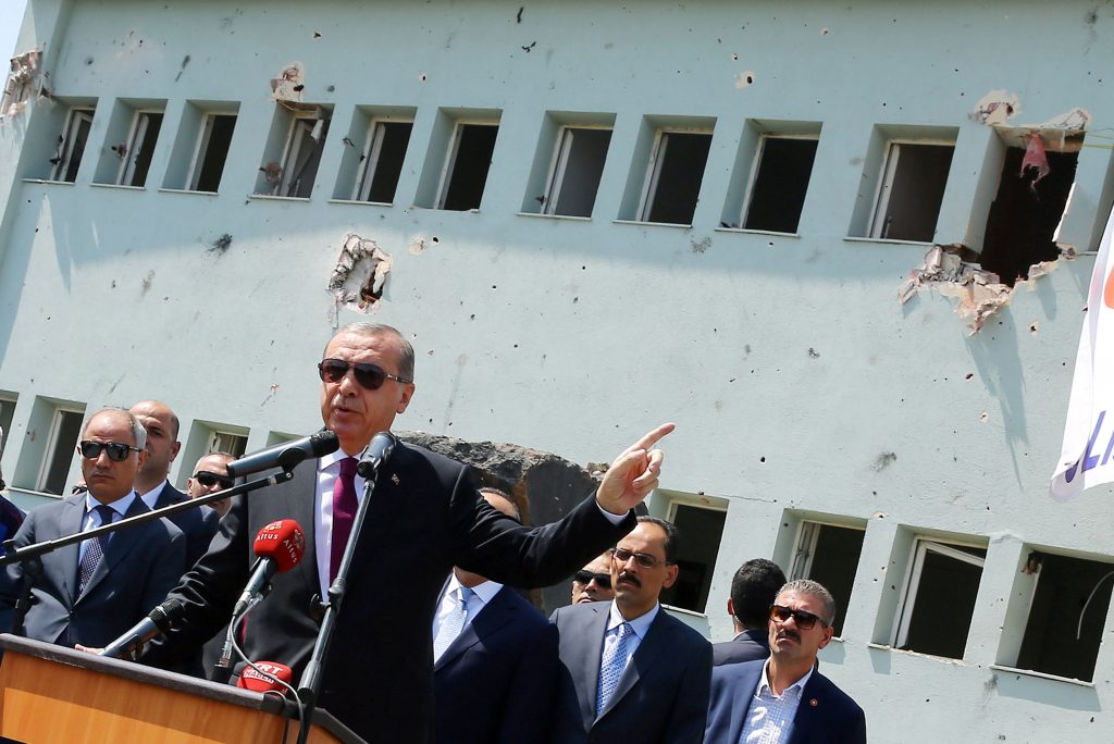 Turkey's President Tayyip Erdogan addresses the audience as he visits the Turkish police special forces base damaged by fighting during a coup attempt in Ankara Turkey