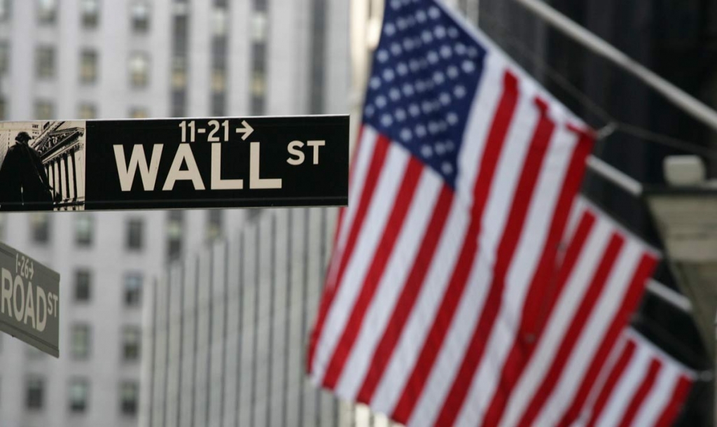 Wall Street sign is shown in New York. Stocks are rising modestly in early morning trading Friday