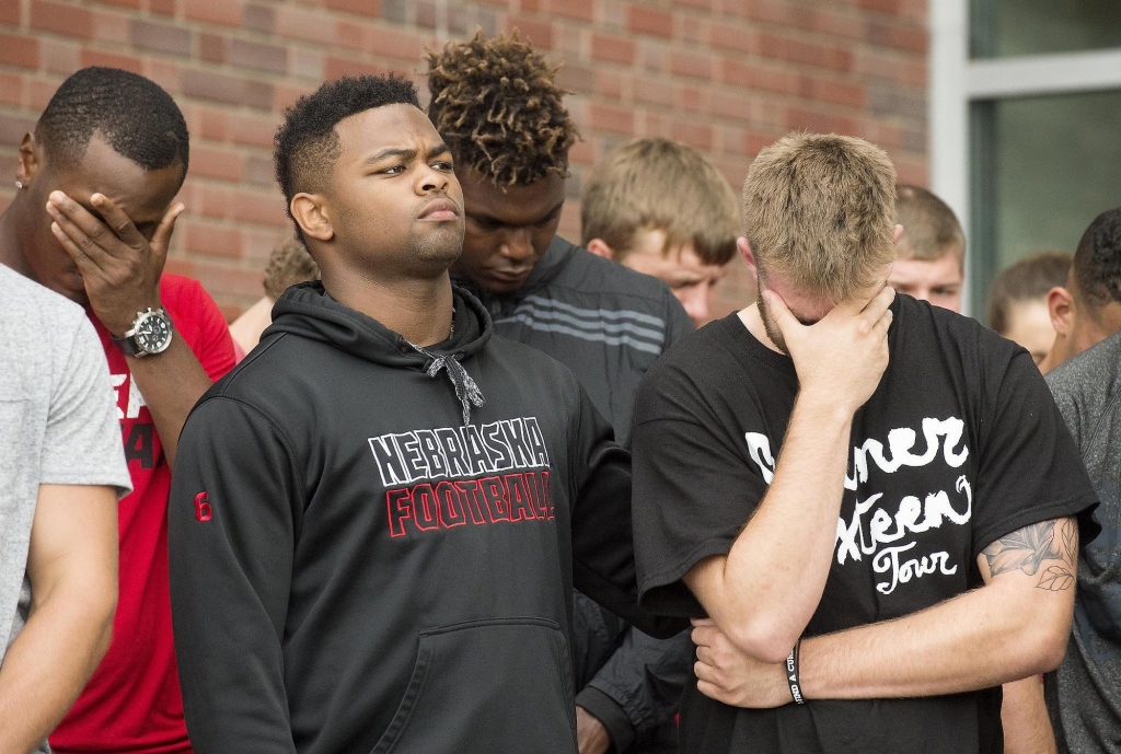 Nebraska football players attend a vigil in Lincoln Neb. for Cornhuskers punter Sam Foltz who died in car accident early Sunday along with former Michigan State punter Mike Sadler