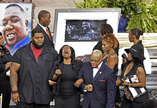 Sandra Sterling an aunt who helped raise Alton Sterling sobs as she is helped away from the casket during visitation before the funeral service fot Sterling at the F.G. Clark Activity Center in Baton Rouge La. Friday