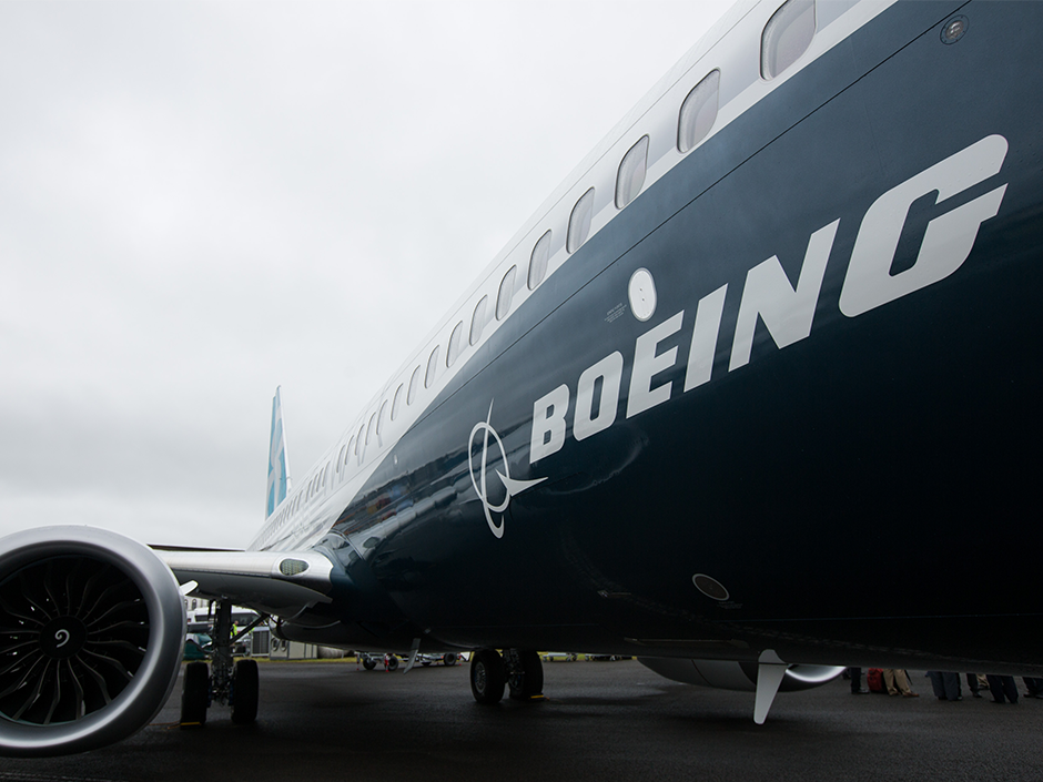 The Boeing Co. logo sits on the side of a 737 Max aircraft during preparations ahead of the Farnborough International Airshow 2016 in Farnborough U.K. Boeing is planning to stretch its Max models to compete with Bombardier's CSeries aircraft