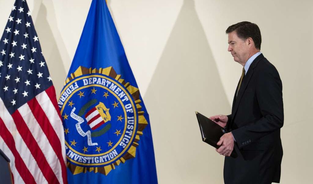 FBI Director James Comey walks to the podium to make a statement at FBI Headquarters in Washington Tuesday