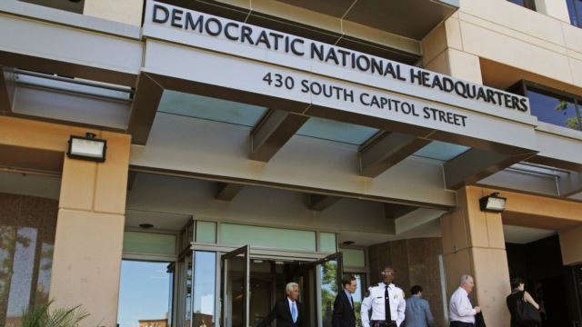 FILE- People stand outside the Democratic National Committee