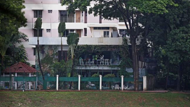 Policemen inspect a site after gunmen attacked the Holey Artisan Bakery and the O`Kitchen Restaurant in Dhaka Bangladesh on 3 July