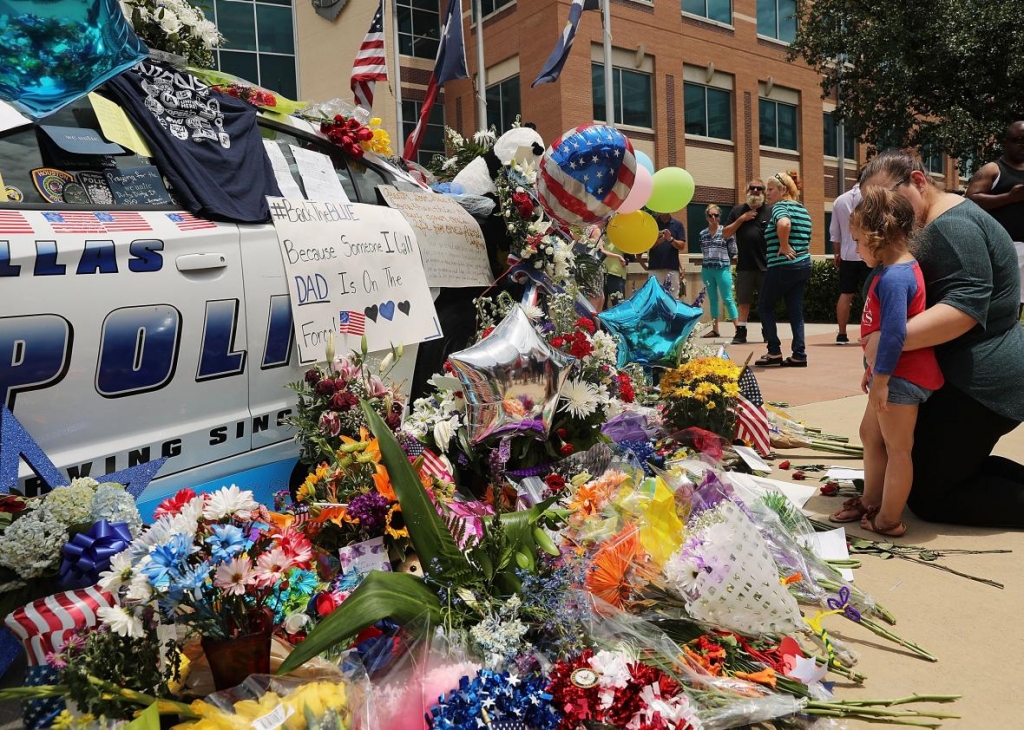 545702624-people-visit-a-growing-memorial-at-the-dallas-police