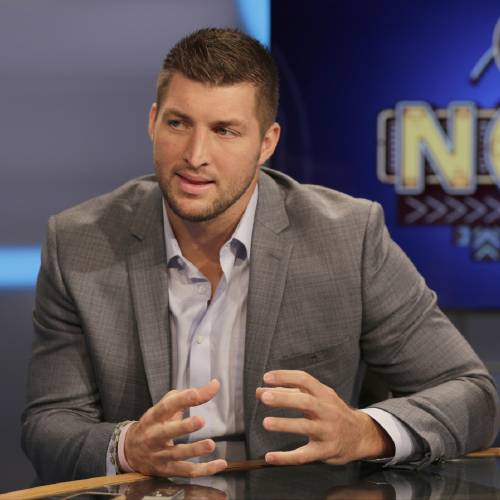 Tim Tebow answers a question during a interview on the set of ESPN's new SEC Network in Charlotte N.C. Tebow will be featured at the Republican National Convention in Cleveland next week. Tebow will