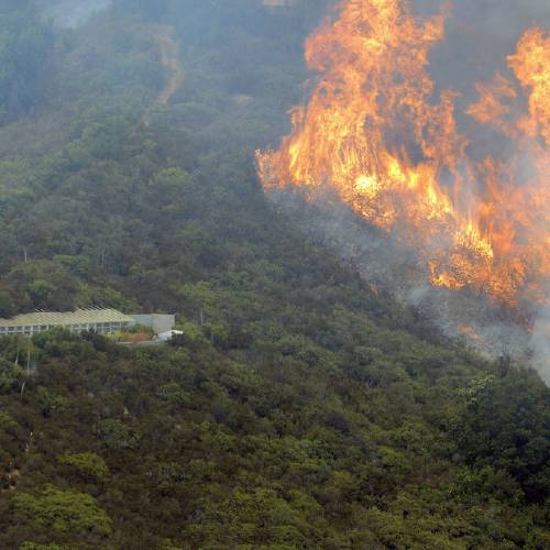 Fire crews have made some gains against a massive wildfire burning in rugged terrain near the scenic Big Sur regio