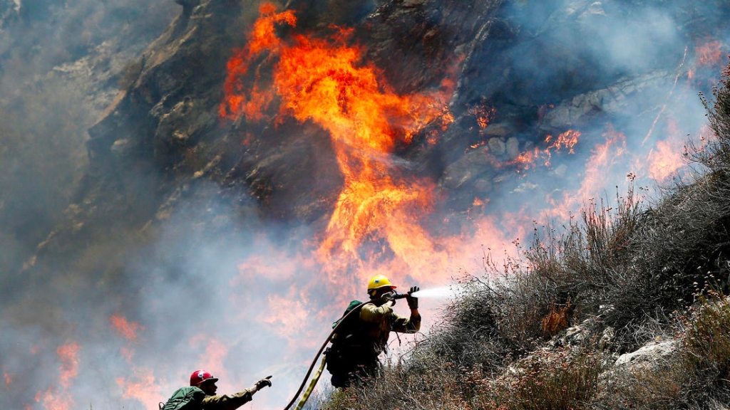 Firefighters battle a spot fire along Soledad Canyon Road near Agua Dulce on Tuesday. (Credit Luis Sinco  Los Angeles Times