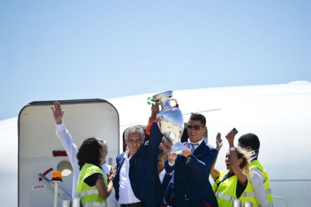 First to greet head coach Santos and Ronaldo holding aloft the trophy airport personnel are ecstatic. — AFP pic