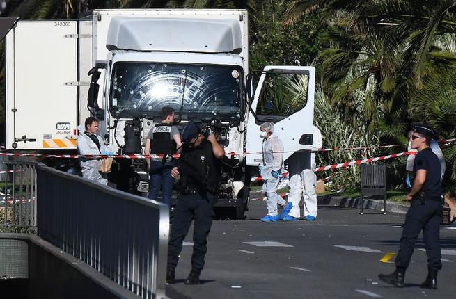 French police and security forces examine the remains of the delivery truck that Mohamed Lahouaiej Bouhlel drove into a crowd of people on Bastille Day