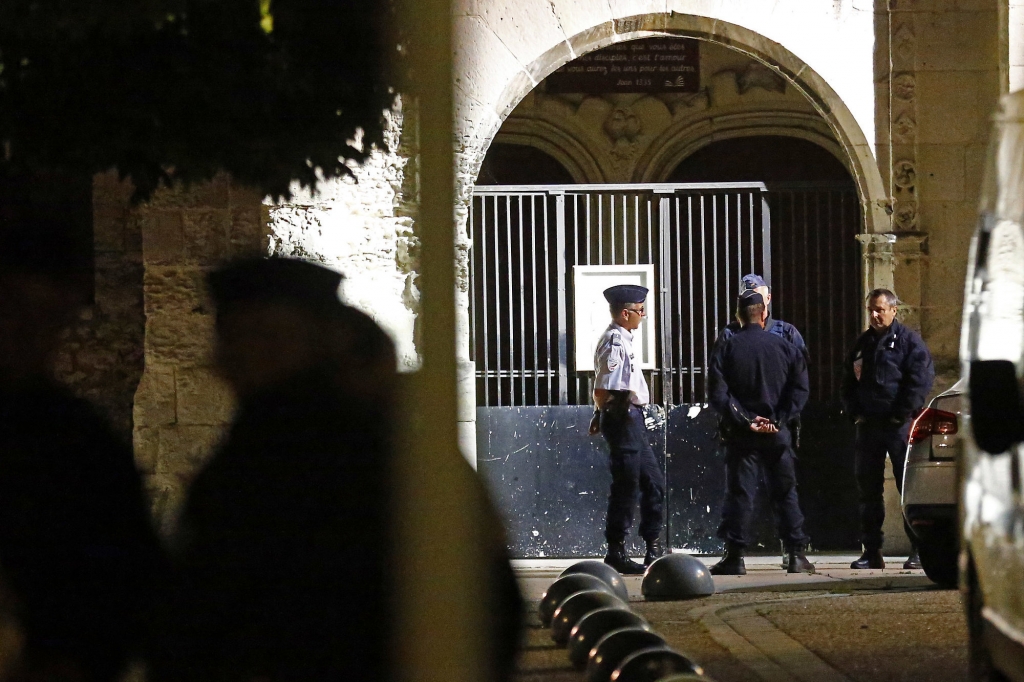 French riot police guards the entrance of the church where an hostage taking left a priest dead in Saint-Etienne-du-Rouvray Normandy France Tuesday