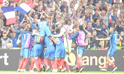 France’s players and fans celebrate after Antoine Griezmann scored the second goal of their semi-final against Germany and France at the Stade Vélodrome in Marseille