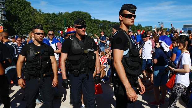 French police officers patrol in the Paris fan zone before the Euro 2016 final soccer match between Portugal and France Sunday