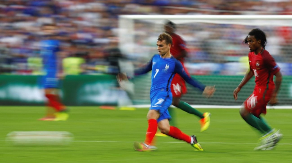 France's Antoine Griezmann in action with Portugal's Renato Sanches