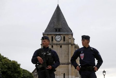 French CRS police stand guard in front of the church a day after a hostage-taking in Saint-Etienne-du-Rouvray near Rouen in Normandy France where French priest Father Jacques Hamel was killed with a knife and another hostage seriously wounded in an