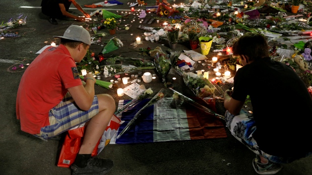 People continue to pay tribute to victims of the Bastille Day truck attack on Sunday with flowers French flags and candles in Nice France