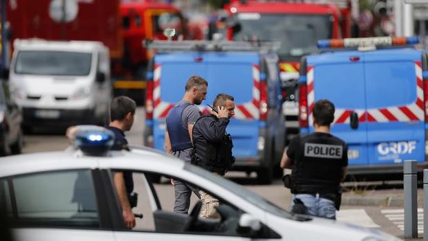 French police officers and firemen arrive at the scene of a hostage-taking at a church in Saint-Etienne-du-Rouvray northern France