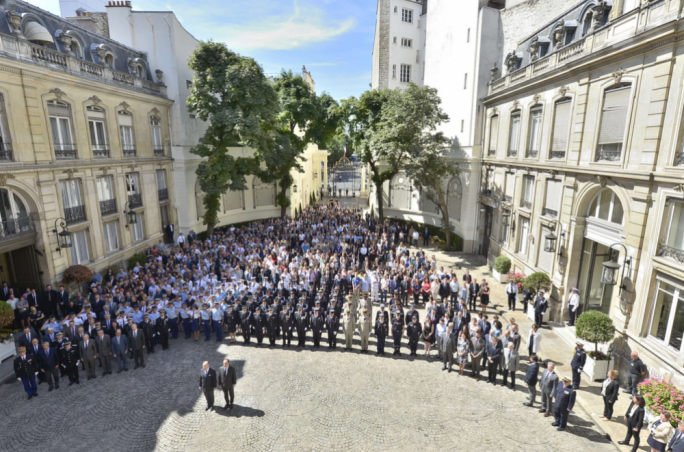 French president Francois Hollande and interior minister Bernard Cazeneuve observe the moment of silence in Beauvau square in Paris