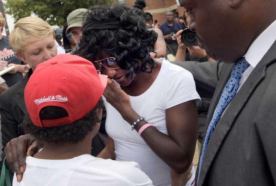 Gloria Darden center the mother of Freddie Gray wipes away tears at a news conference held by Baltimore State's Attorney Marilyn Mosby after prosecutors dropped remaining charges against the three Baltimore police officers who were awaiting trial in Fr