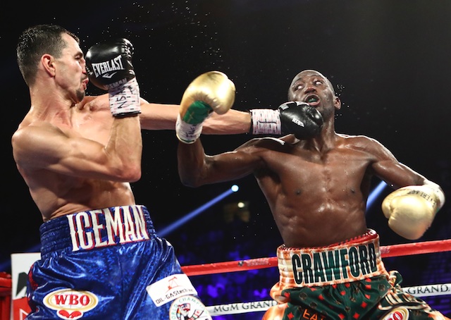 Viktor Postol left hits Terence Crawford during their WBC-WBO junior welterweight title unification boxing bout in Las Vegas on Saturday