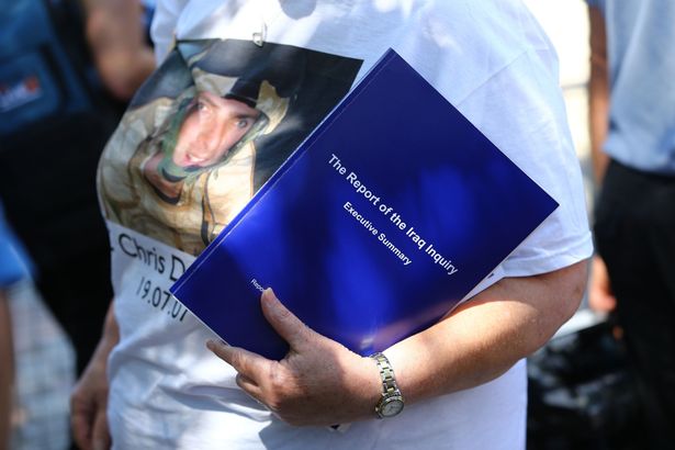 A woman wearing a t-shirt in tribute to Senior Aircraftsman Christopher Dunsmore who died in Iraq carries the Iraq Inquiry Report as she leaves the Queen Elizabeth II Conference Centre London after the publication of the Chilcot inquiry into the Iraq