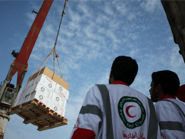 Iranian Red Crescent aid workers observe loading medical aid onto the 'Iran Shahed&#039 ship to send to Gaza Strip in the southern port city of Bandar Abbas