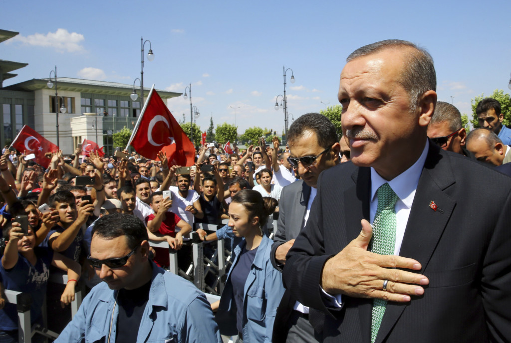 Turkey's President Recep Tayyip Erdogan acknowledges the crowd as he arrives at the parliament in Ankara Turkey. Turkish lawmakers approved a three-month state of emergency that allows the government to extend detent