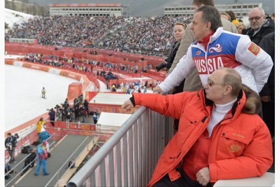 8 2014 Russian President Vladimir Putin foreground watches downhill ski competition of the 2014 Winter Paralympics in Roza Khutor mountain district of Sochi Russia as Russia's sports minister Vitaly Mu